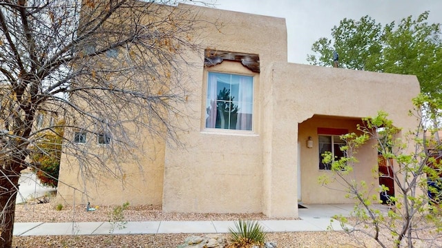 view of side of property with stucco siding