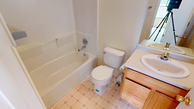 full bath with toilet, vanity, and shower / bathing tub combination