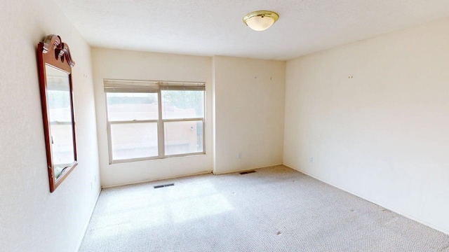 carpeted spare room with visible vents