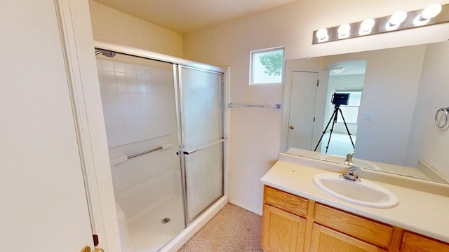 bathroom featuring a shower stall and vanity