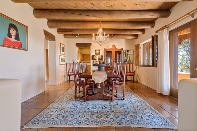 tiled dining room featuring wood ceiling, beam ceiling, and a chandelier