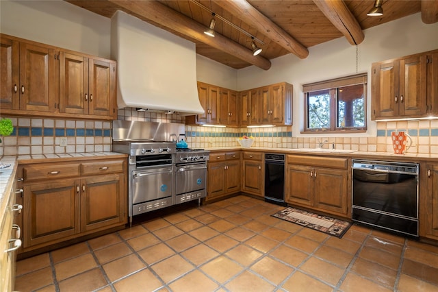 kitchen with tile counters, dishwasher, wood ceiling, and range with two ovens