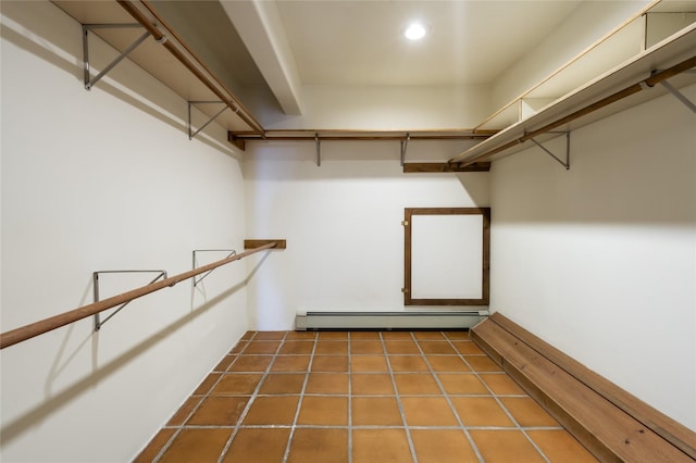 walk in closet featuring a baseboard heating unit and tile patterned flooring