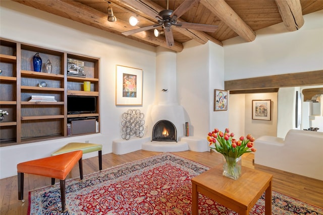sitting room with wood finished floors, beam ceiling, and wood ceiling