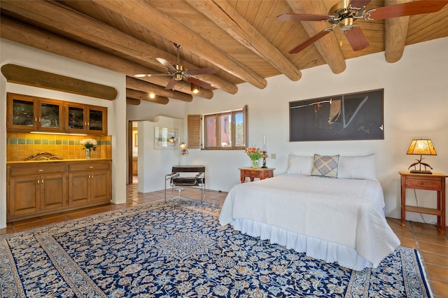 bedroom featuring beam ceiling, wood ceiling, and light tile patterned floors