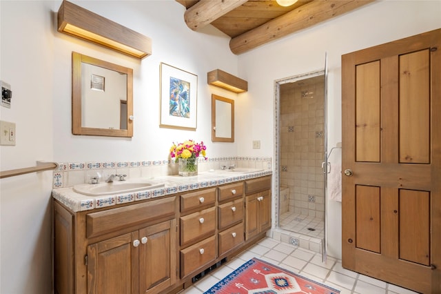 bathroom with beam ceiling, tile patterned flooring, a stall shower, and a sink
