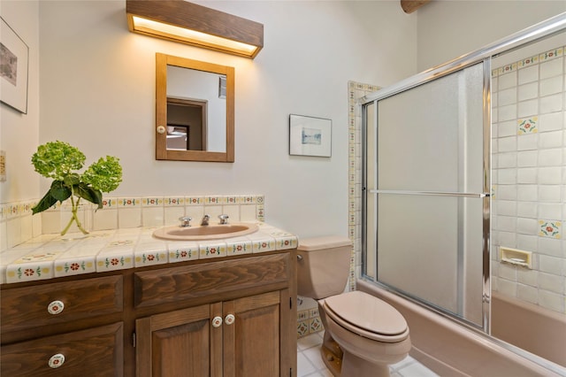 bathroom featuring vanity, shower / bath combination with glass door, and toilet
