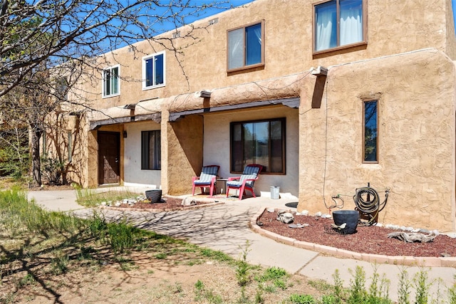 back of property with stucco siding