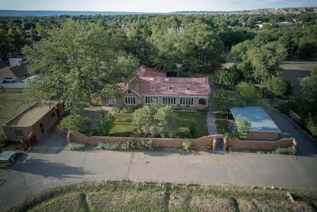 birds eye view of property with a view of trees
