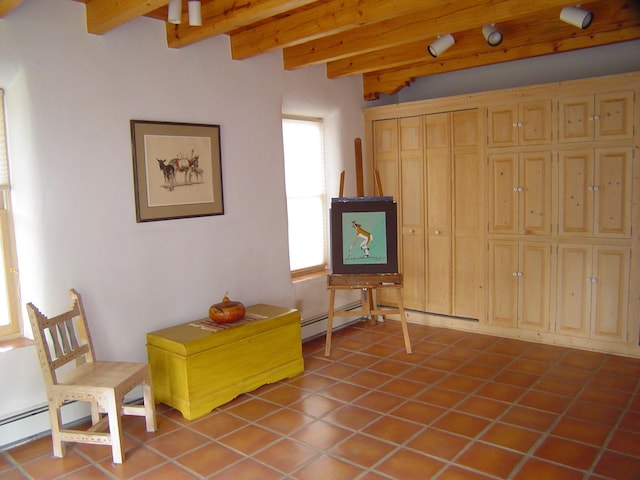 sitting room with beamed ceiling, tile patterned floors, and a baseboard radiator
