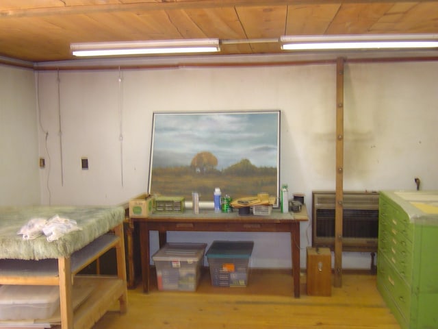 basement featuring wood ceiling and wood finished floors