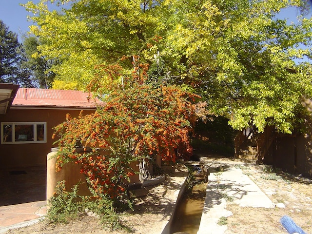 exterior space with stucco siding and metal roof