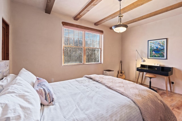bedroom featuring wood finished floors and beamed ceiling