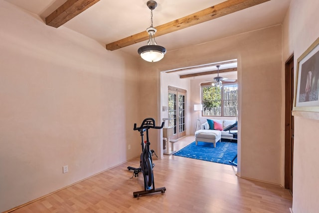 exercise room with french doors, wood finished floors, and ceiling fan