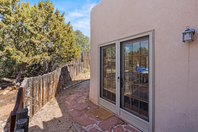 exterior space featuring fence and stucco siding