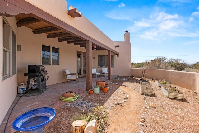 view of yard featuring fence, a patio area, a garden, and french doors