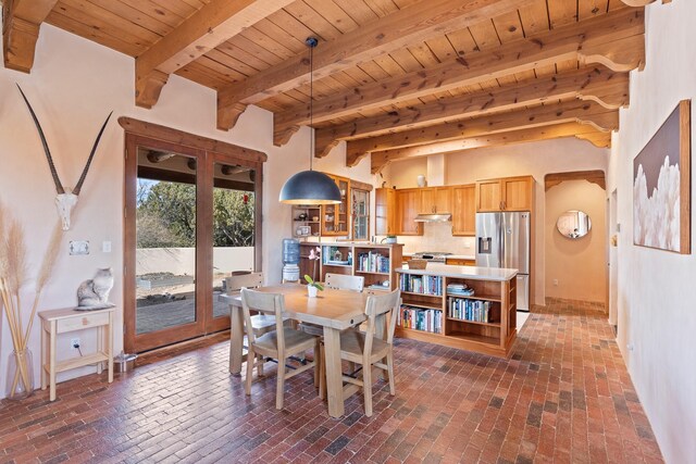dining room featuring brick floor, beam ceiling, and wood ceiling