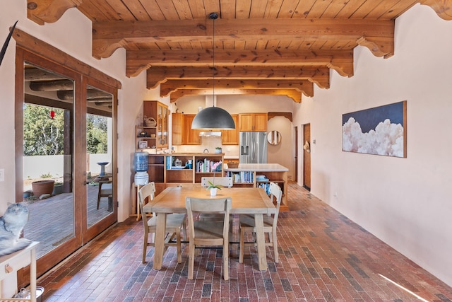 dining area featuring brick floor, wood ceiling, and french doors