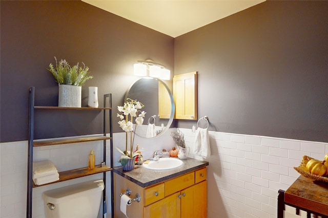 4715 Quemazon, Los Alamos, NM 87544 - bathroom featuring tile walls, toilet, vanity, and wainscoting