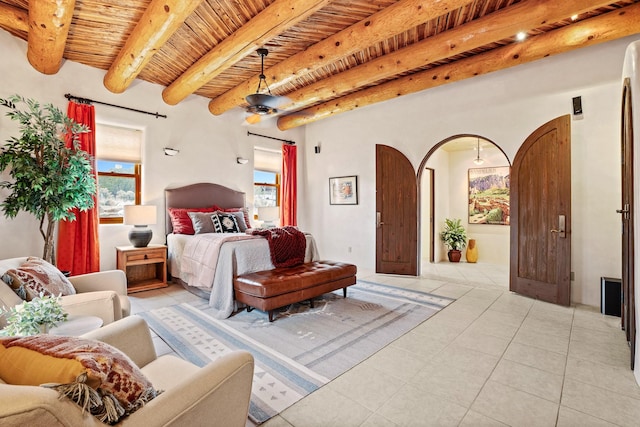 bedroom featuring beamed ceiling, wooden ceiling, arched walkways, and light tile patterned floors
