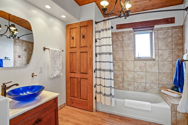 full bath featuring an inviting chandelier, recessed lighting, shower / tub combo, wood finished floors, and vanity