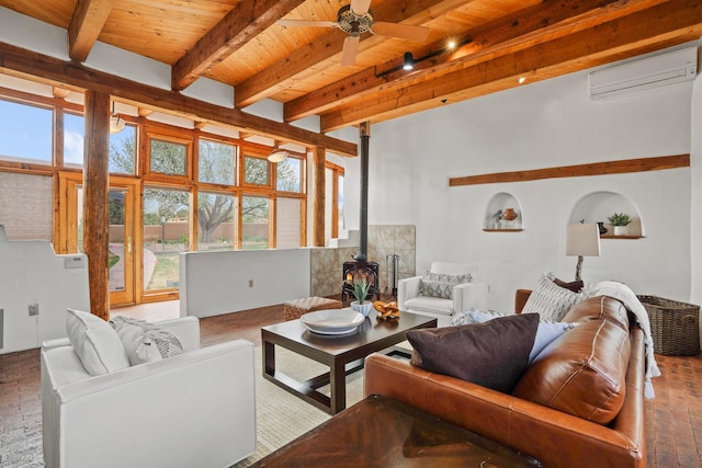 living area with a wood stove, a wall unit AC, beam ceiling, wood ceiling, and ceiling fan