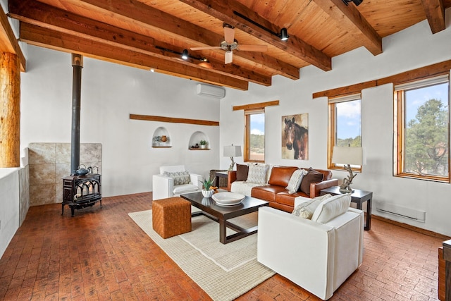 living room with beam ceiling, brick floor, wooden ceiling, a wall mounted AC, and a wood stove