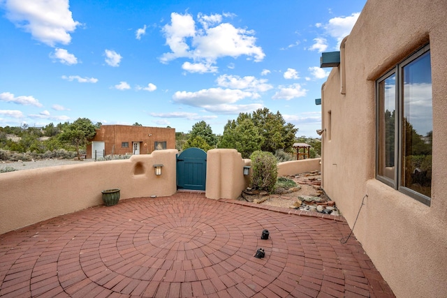 view of patio / terrace featuring fence and a gate