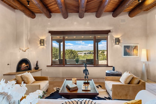 tiled living room featuring wooden ceiling, beam ceiling, and a fireplace
