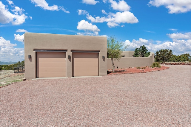 detached garage featuring fence
