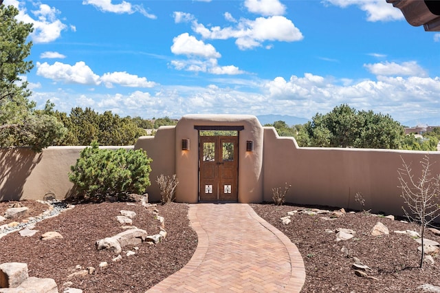 property entrance with french doors and fence