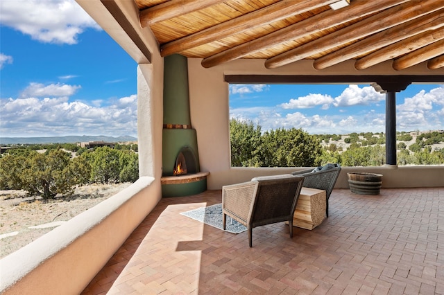 view of patio with a large fireplace