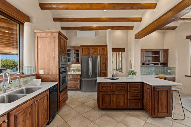 kitchen with decorative backsplash, stainless steel appliances, light countertops, and a sink