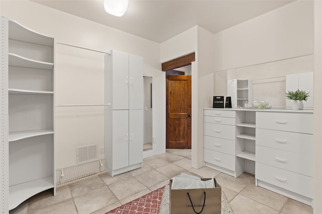 bathroom with visible vents, tile patterned flooring, and a closet