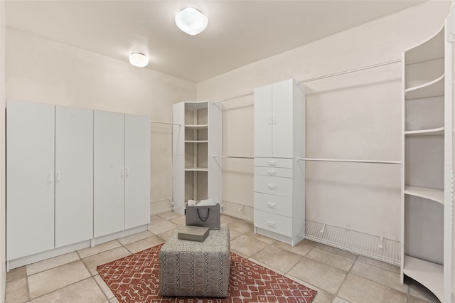walk in closet featuring light tile patterned floors