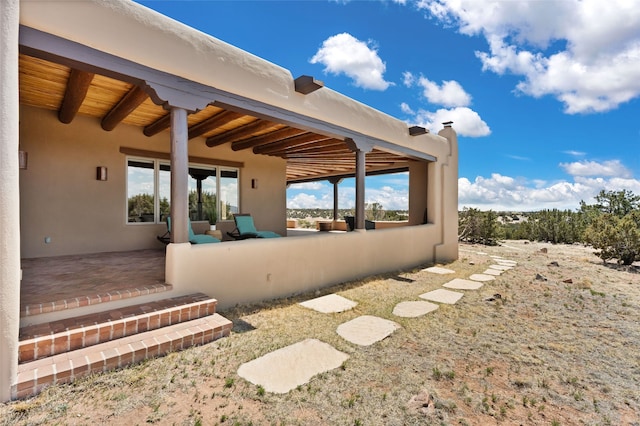 exterior space featuring stucco siding and a patio