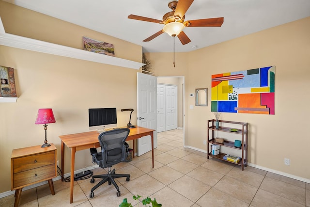 home office featuring baseboards, a ceiling fan, and tile patterned flooring