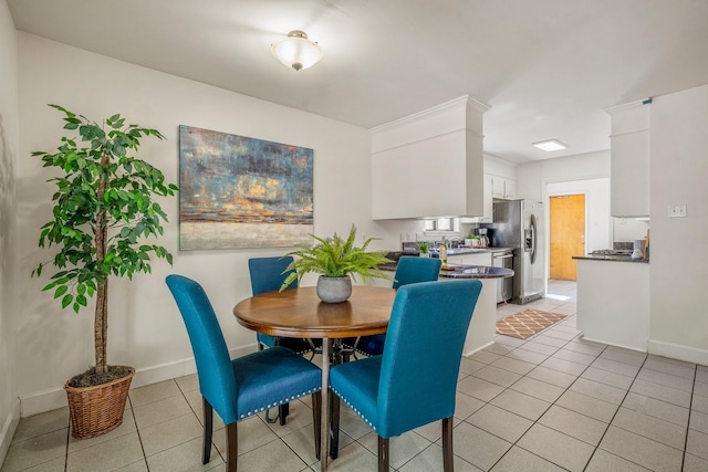 dining room with light tile patterned flooring and baseboards