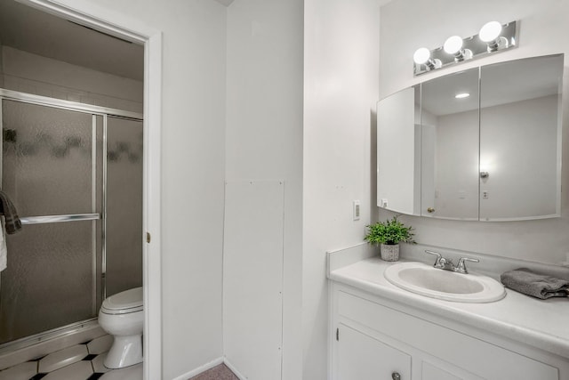 bathroom featuring toilet, vanity, and a stall shower