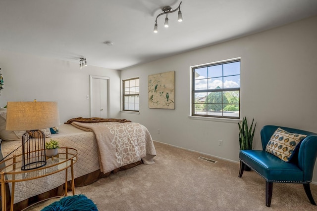bedroom featuring baseboards, visible vents, and carpet