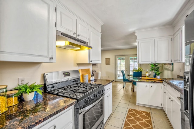 kitchen featuring under cabinet range hood, french doors, gas stove, and white cabinetry