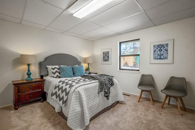 carpeted bedroom with a paneled ceiling, visible vents, and baseboards