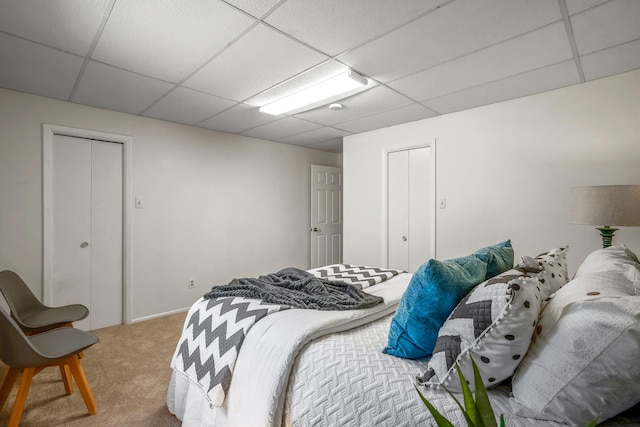 bedroom with carpet, a closet, and a drop ceiling