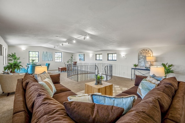 living room with vaulted ceiling, carpet floors, and baseboards