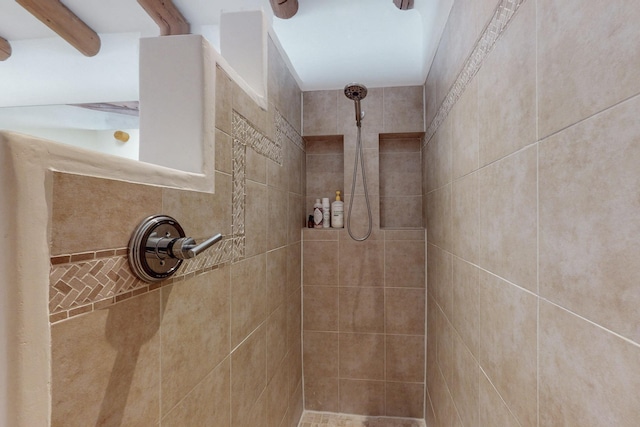 full bath with a tile shower