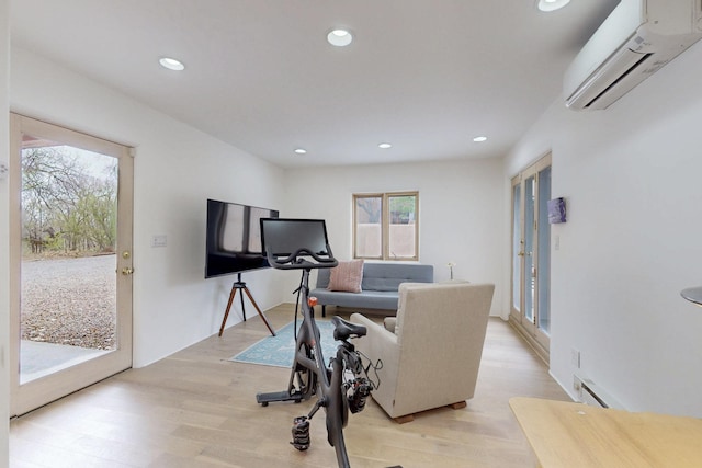 workout room featuring recessed lighting, light wood-type flooring, an AC wall unit, and baseboard heating