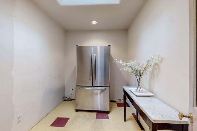 kitchen featuring light floors, freestanding refrigerator, and recessed lighting
