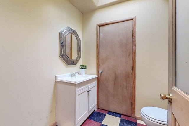 bathroom with tile patterned floors, vanity, and toilet