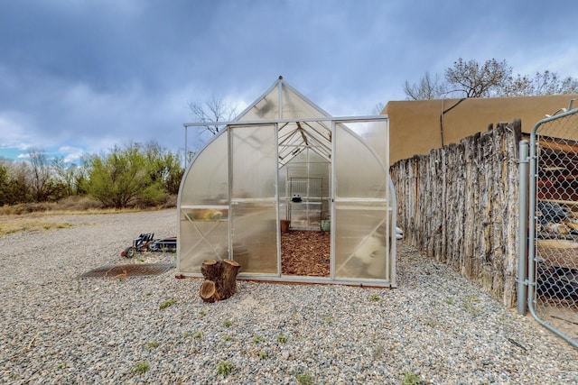 view of greenhouse with fence