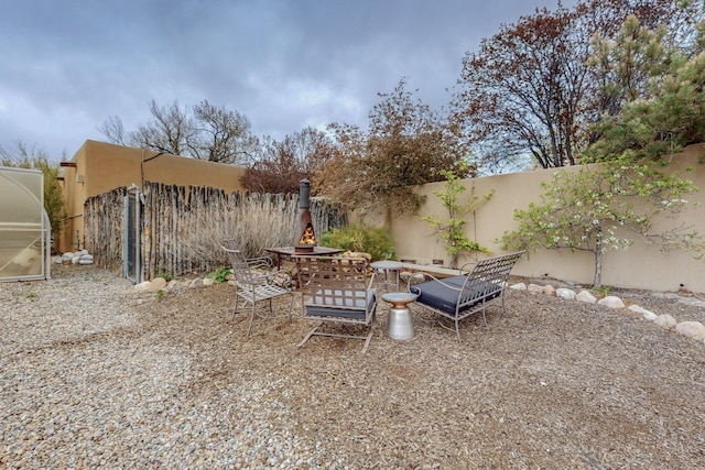 view of yard featuring fence and a fire pit